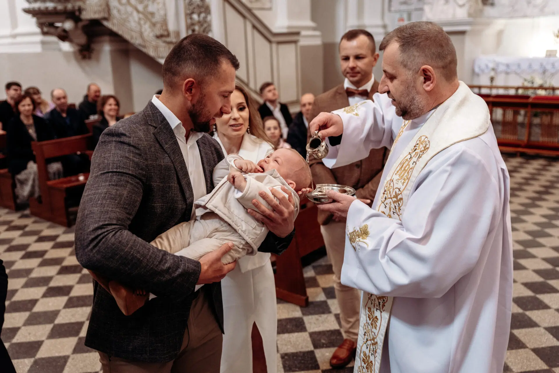 Švento vandens pylimas ant kūdikio, krikšto ceremonija